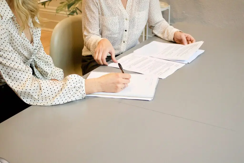 A photo of two people discussing documents