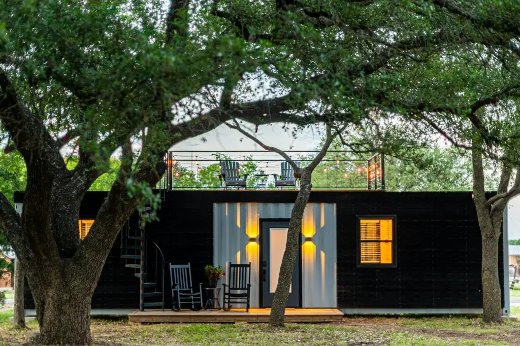 A photo of a modern container home located in the forest