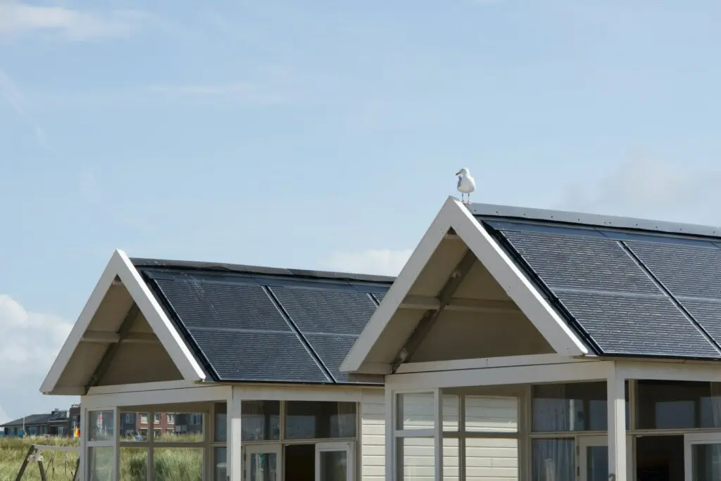 A photo of solar panels installed on the roof within a community