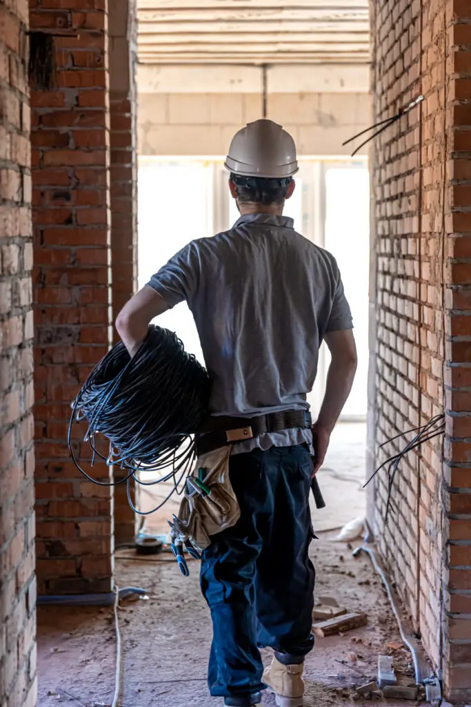 An electrician contractor standing in the middle of a worksite