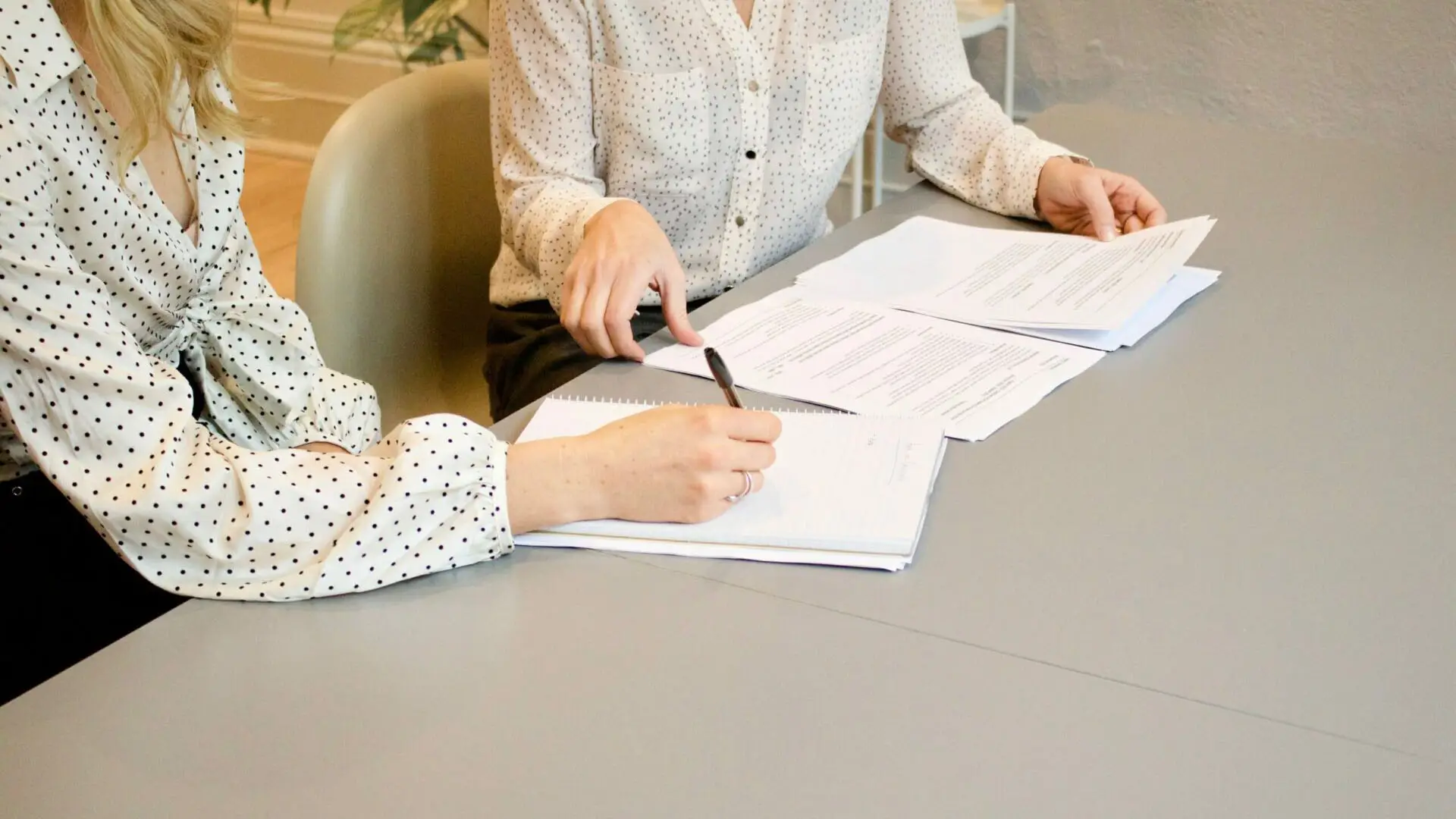 Two people discussing documents