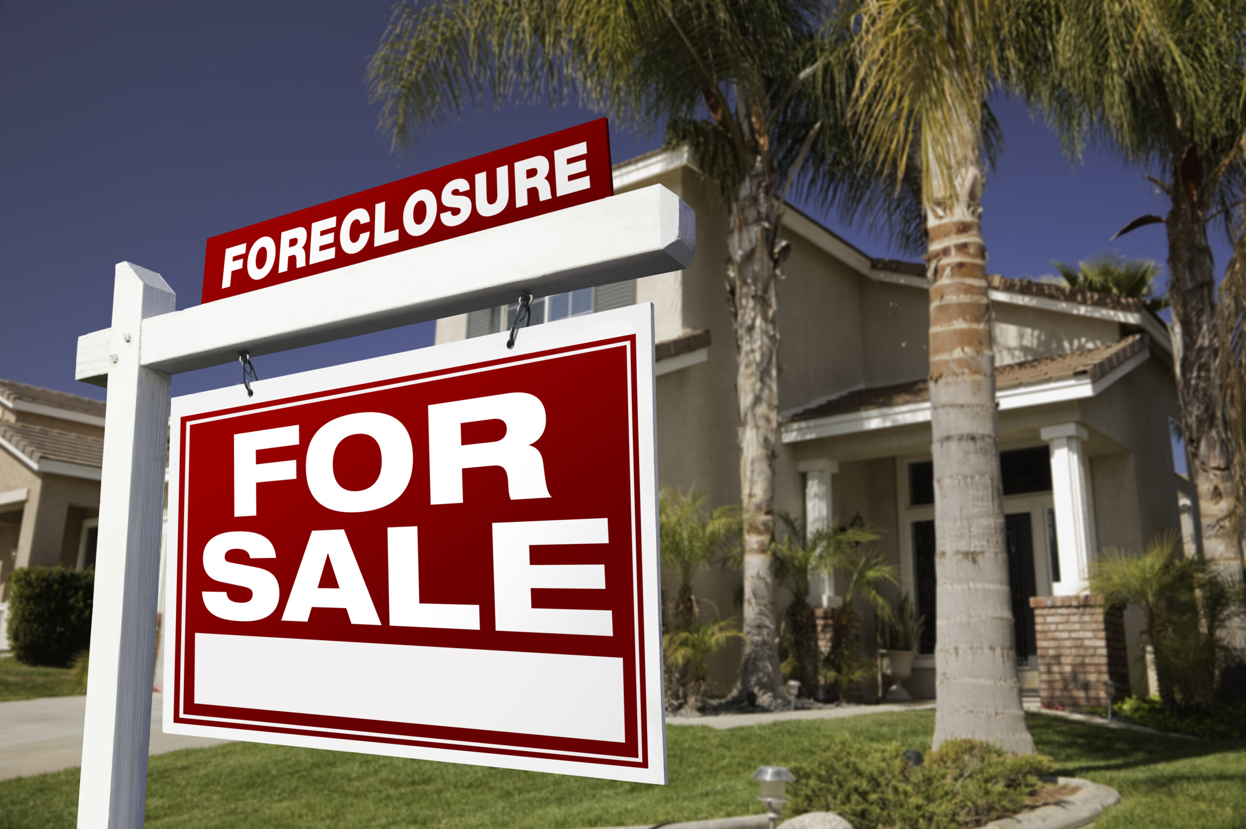 Foreclosure For Sale Real Estate Sign in Front of House.